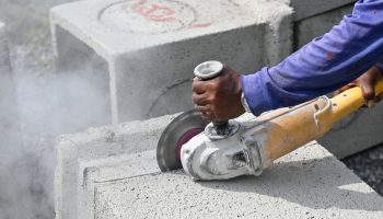 Construction worker using a machine for granite cutting